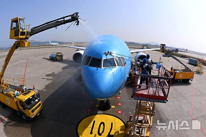 [서울=뉴시스] 김명년 기자 = 24일 오전 인천국제공항에 위치한 대한항공 정비 격납고에서 관계자들이 봄맞이 항공기 동체 세척을 하고 있다.(공동취재) 2025.04.24. kmn@newsis.com