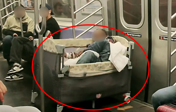 최근 뉴욕 지하철에서 한 성인 남성이 아기 침대에 누워있는 모습이 포착됐다. 틱톡 swintonodyssey 캡처