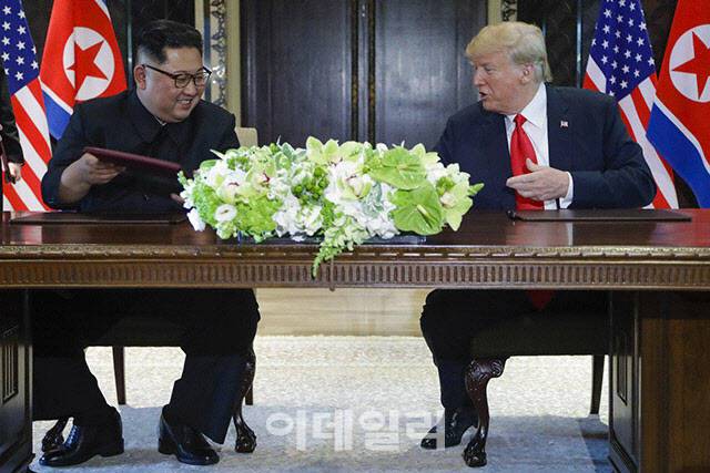도널드 트럼프(오른쪽) 미국 대통령과 김정은 북한 국무위원장이 2018년 6월 싱가포르 센토사섬 카펠라 호텔에서 첫 북미 정상회담을 가진 뒤 공동선언에 서명했다. [AP통신=연합뉴스]