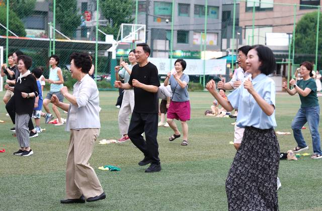 조성명(가운데) 서울 강남구청장이 개방학교 운동장(신구초등학교)에서 주민과 함께 운동을 하고 있다. 강남구청 제공