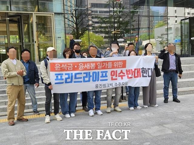 웅진그룹이 프리드라이프 인수 계약을 체결한 가운데, 인수자금 조달에 동원된 웅진씽크빅의 자금 보충 약정을 두고 소액주주들이 집단행동에 나섰다. 30일 서울 중구 웅진그룹 본사 앞에서 웅진씽크빅 소액주주들이 프리드라이프 인수에 반대하는 시위에 참여하고 있다. /우지수 기자