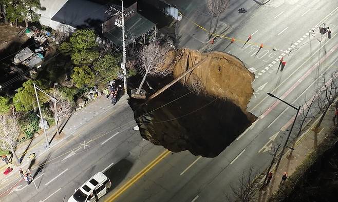 24일 저녁 서울 강동구 명일동 대명초교 사거리 인근에서 대형 땅꺼짐 사고가 발생해 경찰과 소방이 현장을 통제하고 있다. 김영원 기자 forever@hani.co.kr