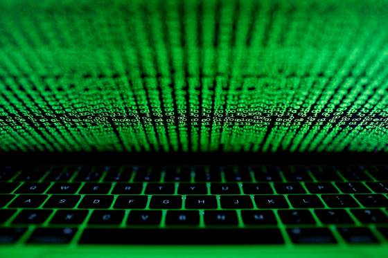A computer keyboard lit by a displayed cyber code is seen in this illustration picture taken on March 1, 2017. [REUTERS/YONHAP]
