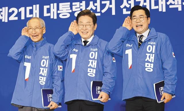 이재명 더불어민주당 대선 후보와 윤여준(왼쪽)·박찬대 상임총괄선대위원장이 30일 서울 여의도 국회 의원회관에서 열린 당 중앙선거대책위원회 출범식에서 국민 목소리에 귀 기울이겠다는 의미의 ‘경청’ 퍼포먼스를 하고 있다. 최현규 기자