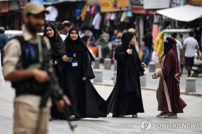 인도 경찰과 무슬림 여성들 인도 잠무 카슈미르 스리나가르의 한 거리에서 무장한 인도 경찰이 서 있는 가운데 차도르를 쓴 인도 여성들이 길을 걷고 있다.
[AFP 연합뉴스 자료사진. 재판매 및 DB 금지]