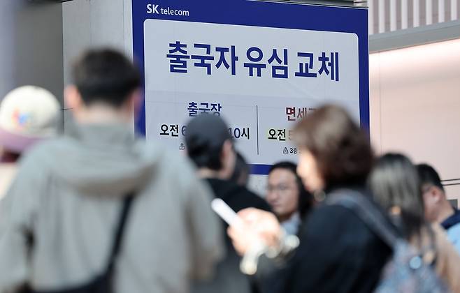 지난 2일 오전 인천국제공항 제1여객터미널 출국장에 마련된 SK텔레콤 로밍센터에서 여행객들이 유심 교체 서비스를 받기 위해 대기하고 있다. /뉴스1