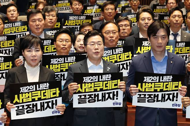 박찬대 더불어민주당 대표 직무대행 겸 원내대표(앞줄 가운데)와 의원들이 4일 오후 서울 여의도 국회에서 열린 긴급 의원총회에서 대법원을 규탄하는 구호를 외치고 있다. /뉴스1