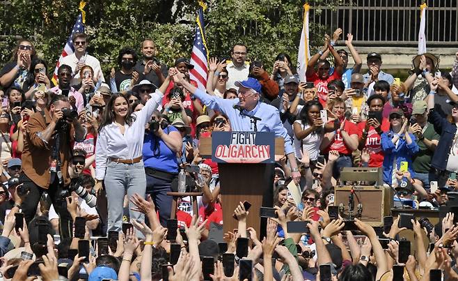알렉산드리아 오카시오-코르테즈 하원의원이 버니 샌더스 상원의원과 함께 지난달 12일 로스앤젤레스 도심에서 집회를 진행하고 있다. UPI연합뉴스