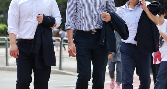 Office workers walk across a street near Namdaemun on May 29, 2024. [YONHAP]