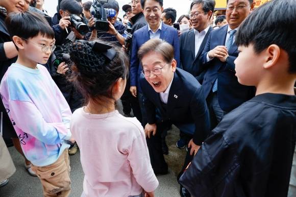이재명(가운데) 더불어민주당 대선 후보가 5일 경기 양평군 양평시장의 문구점 앞에서 자세를 낮추고 어린이들과 대화하며 웃고 있다. 이 후보는 이날 경기 양평·여주와 충북 음성·진천을 차례로 방문하는 2차 ‘골목골목 경청투어’를 이어 갔다. 뉴스1