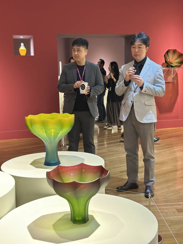 2025년 클레이아크김해미술관 특별 기획전 ‘유리: 빛과 불의 연금술’에 전시 중인 유리 작품과 김준용(오른쪽) 작가. 김은영 기자