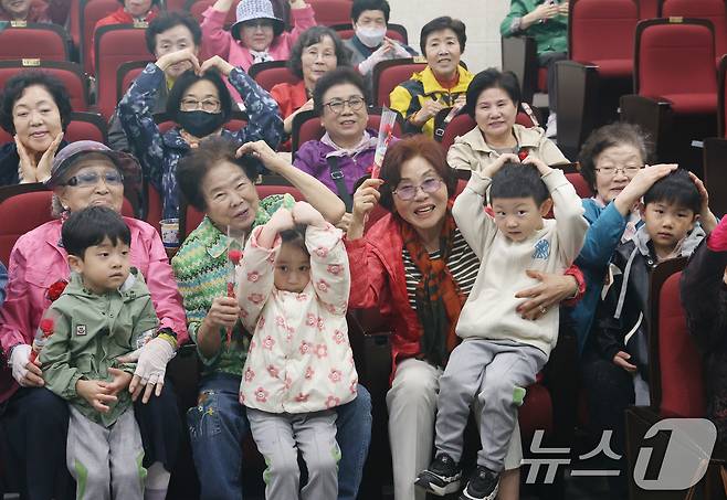 어버이날을 하루 앞둔 7일 오전 경기 수원시 팔달구 팔달노인복지관에서 관내 어린이집 아이들이 어르신들에게 카네이션을 달아드리고 머리 위로 하트를 만들어보이고 있다. 2025.5.7/뉴스1 ⓒ News1 김영운 기자