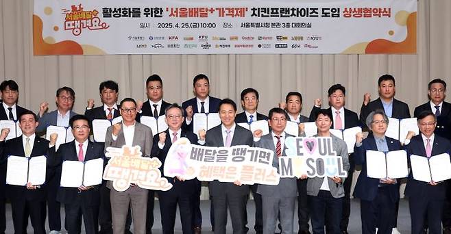 오세훈 서울시장이 지난달 25일 서울 중구 서울시청에서 열린 서울배달+ 땡겨요 활성화를 위한 '서울배달+ 가격제' 치킨프랜차이즈 도입 상생 협약식에서 치킨프랜차이즈 대표 등 참석자와 기념촬영을 하고 있다. ⓒ뉴시스