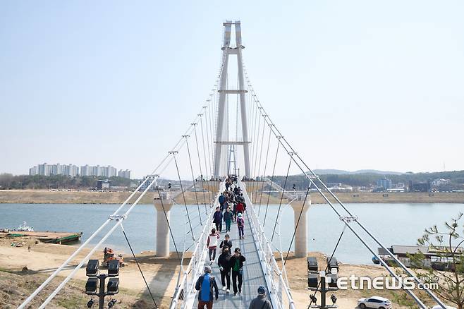 경기도와 여주시가 1일 개통한 '여주 남한강 출렁다리'를 관광객들이 건너고 있다.