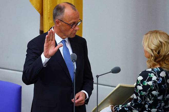 프리드리히 메르츠(왼쪽) 독일 기민당(CDU) 대표가 6일(현지시간) 베를린 연방의회에서 총리 선서를 하고 있다. 메르츠 총리는 이날 2차 투표 끝에 간신히 총리에 선출됐다. 로이터 연합