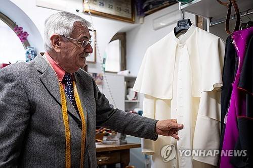 재단사 가 신임 교황이 입게 될 예복을 만져보고 있다. AFP연합뉴스