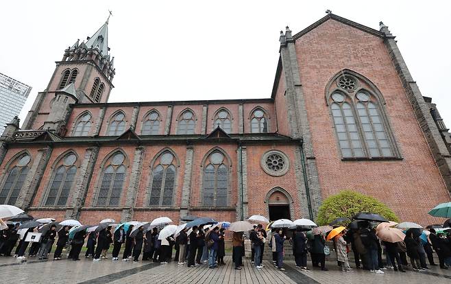 People in line to pay respects to the late Pope Francis at a memorial at Myeongdong Cathedral in Seoul on Tuesday (Yonhap)