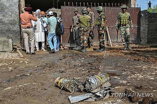 인도·파키스탄 무력 충돌 인도 암리차르 외곽에서 인도 방공 시스템에 의해 요격된 드론에 실린 폭발물 옆에 인도군 병사들이 서 있다. 
[AFP 연합뉴스 자료사진. 재판매 및 DB 금지]
