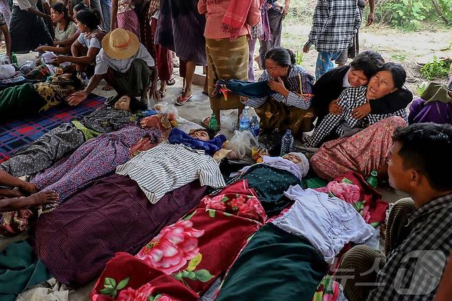 12일(현지시간) 미얀마 사가잉 지역 데파인타운십의 오헤 테인 트윈 마을에서 미얀마군의 폭격으로 사망한 희쟁자들의 장례식에서 유가족을 비롯한 참석자들이 오열하고 있다.ⓒ AFP=뉴스1