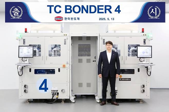 곽동신 한미반도체 회장이 'TC본더 4' 장비 앞에서 기념 촬영을 하고 있다. 한미반도체 제공