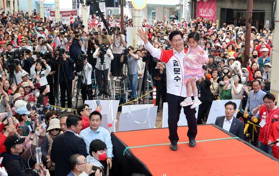 국민의힘 김문수 대선후보가 13일 울산 중구 뉴코아아울렛 울산 성남점 앞 유세장에서 어린아이를 안고 지지자들에게 손을 흔들고 있다 임현동 기자