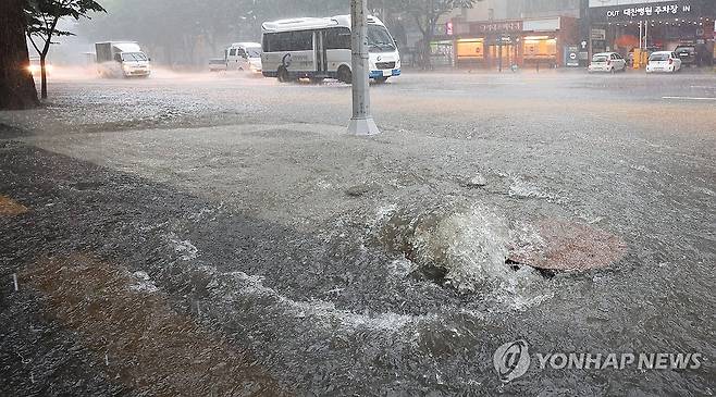 작년 7월 22일 오전 인천 남동구 구월동 시청입구 삼거리 도로 맨홀에서 빗물이 역류하고 있다. [연합뉴스 자료사진]