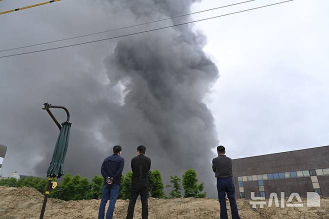 [광주=뉴시스] 박기웅 기자 = 17일 오전 7시11분께 광주 광산구 소촌동 금호타이어 광주공장에서 불이 난 가운데 시민들이 공장에서 피어오르는 검은 연기를 바라보고 있다. 이날 불은 타이어 생산에 필요한 고무를 정련하는 과정에서 발생한 것으로 추정되고 있다. 2025.05.17. pboxer@newsis.com