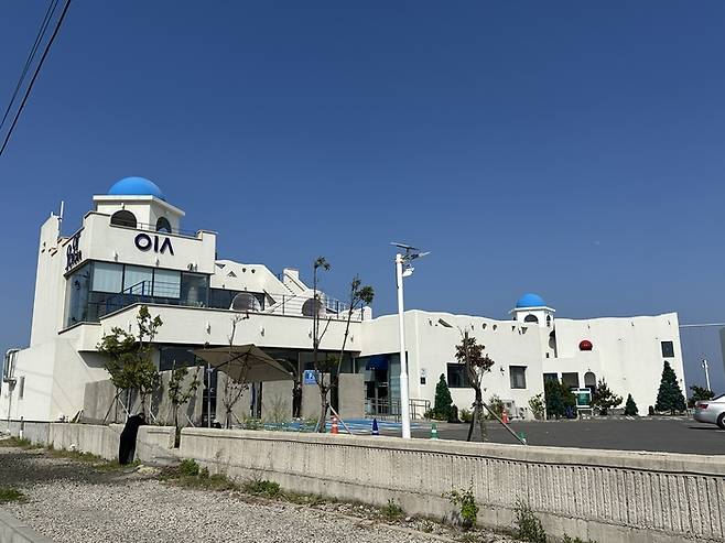 흰 건물에 파란 지붕이 인상적인 오이아카페.  /사진= 강예신 기자