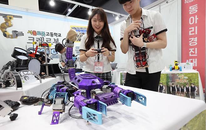 '매경 고졸성공취업창업 페스타'에 참가한 서울로봇고등학교 학생들이 전시된 로봇을 직접 조작하고 있다. 매경DB