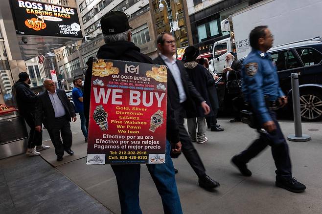 미국 맨해튼 다이아몬드 거리에서 금 매매를 광고 중인 보석상 관계자./AFP 연합뉴스