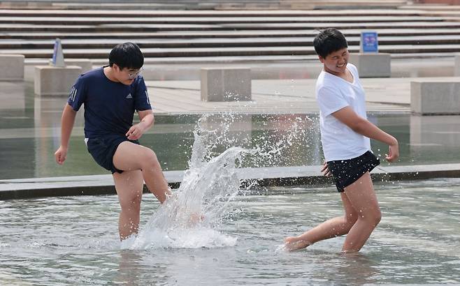초여름의 날씨로 낮 최고기온이 20∼29도를 보인 지난 13일 서울 영등포구 여의도물빛광장에서 현장체험학습을 마친 중학생들이 물놀이를 하며 더위를 식히고 있다. 연합뉴스