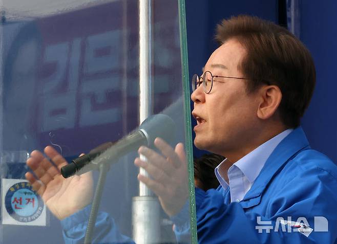 [인천=뉴시스] 조성우 기자 = 이재명 더불어민주당 대선후보가 21일 인천 계양구 계양역 앞에서 열린 유세에서 연설하는 가운데 방탄 유리에 김문수 국민의힘 대선후보 현수막이 투영되고 있다. 2025.05.21. xconfind@newsis.com