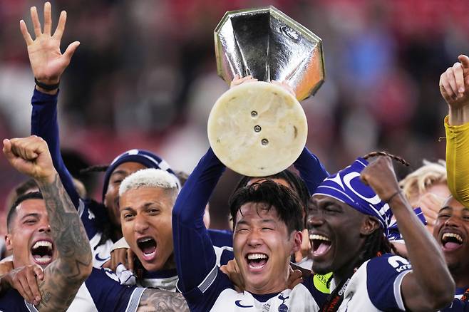 <yonhap photo-2825=""> Tottenham's Son Heung-min holds the trophy aloft as he celebrates with teammates after winning the Europa League final soccer match against Manchester United at the San Mames Stadium in Bilbao, Spain, Wednesday, May 21, 2025. (AP Photo/Manu Fernandez)/2025-05-22 06:30:25/ <저작권자 ⓒ 1980-2025 ㈜연합뉴스. 무단 전재 재배포 금지, AI 학습 및 활용 금지></yonhap>