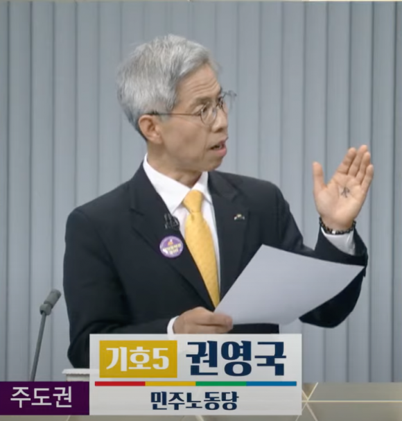 권영국 민주노동당 대선 후보가 23일 서울 영등포구 KBS 스튜디오에서 열린 대선 후보 2차 TV토론회에서 손바닥에 ‘民’자를 적고 나온 모습. KBS 유튜브 캡처