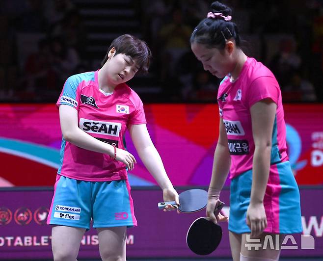 [서울=뉴시스] 사진공동취재단 = 신유빈, 유한나가 24일(현지시간) 카타르 도하 루사일 아레나에서 열린 2025 국제탁구연맹(ITTF) 세계선수권대회 여자복식 4강 소피아 폴차노바(오스트리아) - 베르나데트 소츠(루마니와)과의 경기에서 실점하자 고개를 숙이고 있다.  2025.05.25  photo@newsis.com