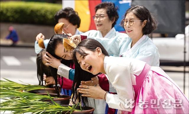 10일 서울 종로구에서 진행한 단오맞이 합동 홍보 행사 중 창포물 머리 감기 시연 모습.