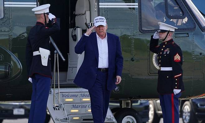 25일 도널드 트럼프 미국 대통령이 워싱턴 디시(D.C)로 출발하기 위해 뉴저지주 모리스타운 시립공항에서 마린원에서 내려 에어포스원에 탑승하고 있다. 모리스타운/로이터 연합뉴스
