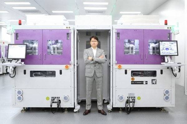 곽동신 한미반도체 회장과 한미반도체의 TC 본더. 사진제공=한미반도체