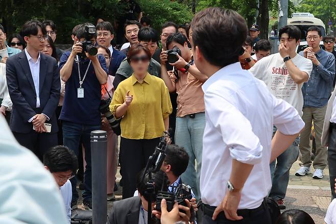 시민한테 항의받는 이준석 후보 - 이준석 개혁신당 후보가 28일 서울 여의도공원에서 유세를 마치고 기자들과 질의응답을 하던 중 한 시민에게 전날 대선 후보 TV 토론에서 이른바 ‘젓가락 발언’을 한 것에 대해 항의를 받고 있다. /연합뉴스