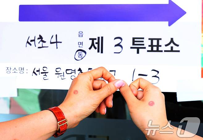 제 21대 대통령 선거일인 3일 오전 서울 서초구 원명초등학교에 마련된 서초4동 제3투표소에서 시민들이 투표를 마치고 인증샷을 촬영하고 있다. 2025.6.3/뉴스1 ⓒ News1 김명섭 기자