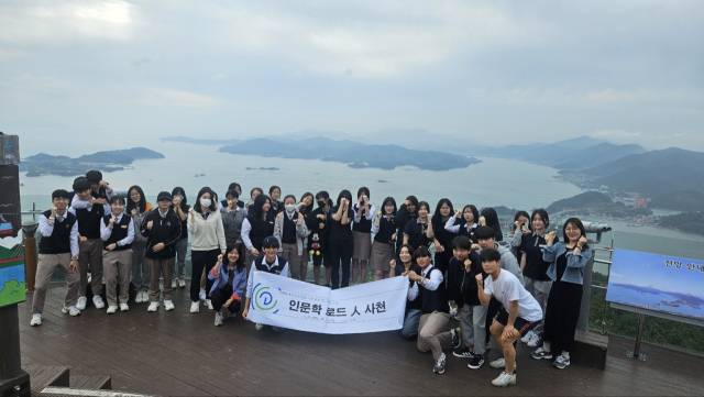 학생들이 케이블카 전망대 앞에서 사천만을 배경으로 사진을 찍고 있다. /사천 용남고/