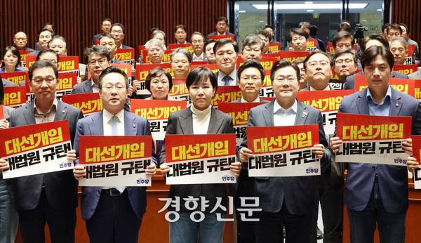 박찬대 더불어민주당 상임총괄선대위원장 및 더불어민주당 의원들이 지난달 4일 국회에서 열린 긴급 의원총회에서 대법원을 규탄하는 손팻말을 들고 구호를 외치고 있다. 한수빈 기자