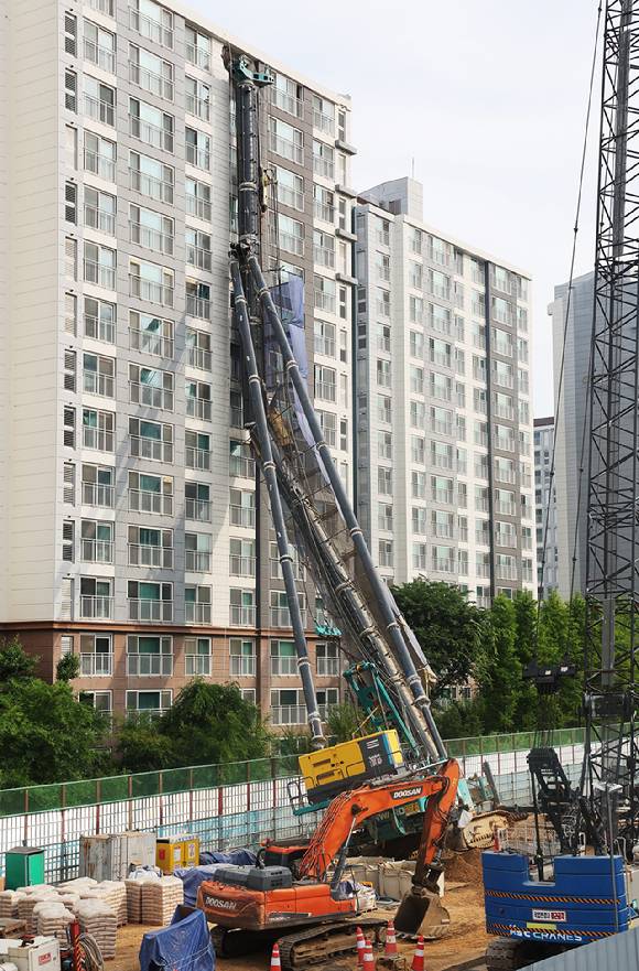6일 경기도 용인시 기흥구 서천동 인덕원~동탄 복선전철 공사 현장에서 중장비인 천공기(지반을 뚫는 건설기계)가 넘어져 인근 아파트 건물 벽면에 기댄 모습으로 쓰러져 있다. [사진=연합뉴스]