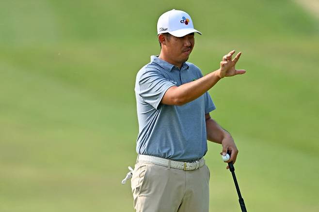 안병훈이 18번홀에서 손바닥을 이용해 그린의 경사를 살피고 있다. (사진=AFPBBNews)