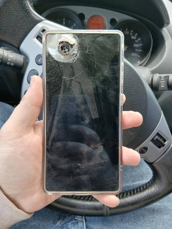 A Samsung Galaxy S25 Ultra phone is seen pierced through with shrapnel in this photo uploaded on Samsung Electronics' Ukrainian website [SCREEN CAPTURE]