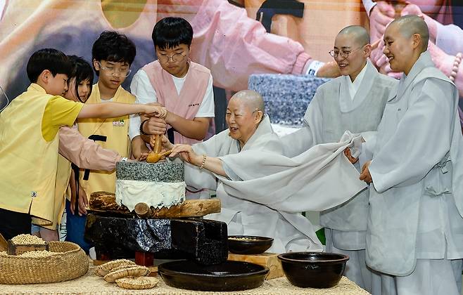 사찰음식 대축제…맷돌 돌리는 어린이들 (서울=연합뉴스) 7일 서울 서초구 aT센터 제1전시장에서 열린 '제4회 사찰음식 대축제'에서 어린이들이 사찰음식 명장 계호스님의 지도를 받아 맷돌을 돌리고 있다. [대한불교조계종 한국불교문화사업단 제공. 재판매 및 DB 금지]