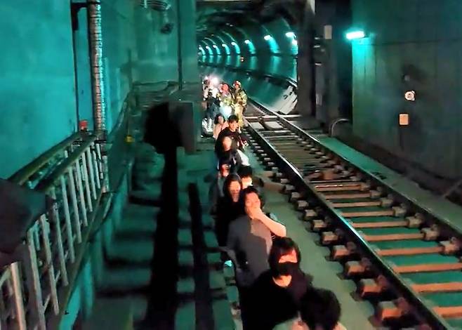 지난달 31일 오전 서울 지하철 5호선 여의나루-마포역 구간에서 방화로 인한 화재가 발생해 승객들이 열차에서 내려 선로를 통해 대피하고 있다./사진=뉴시스.