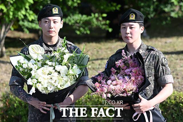 그룹 방탄소년단(BTS)의 정국(왼쪽)과 지민이 11일 오전 경기 연천군 연천공설운동장에서 군 복무를 마친 후 취재진과 팬들을 만나 포즈를 취하고 있다. /연천=서예원 기자