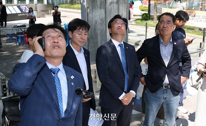 국회 환경노동위원회 소속 더불어민주당 의원들과 한창민 사회민주당 의원이 12일 서울 중구 한화빌딩 앞 고공농성장을 찾아 김형수 금속노조 거제통영고성조선하청지회장과 전화를 하고 있다. 김 지회장은 이날로 90일째 고공농성을 벌이고 있다. 성동훈 기자