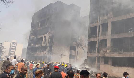 12일(현지시간) 인도 서부 구자라트주 아메다바드 국제공항 인근에서 인도 항공사 에어인디아의 AI171 여객기가 추락했다. 항공기 추락으로 피해를 입은 건물 주변에서 시민들과 구조대가 모여 있다. 신화=연합뉴스